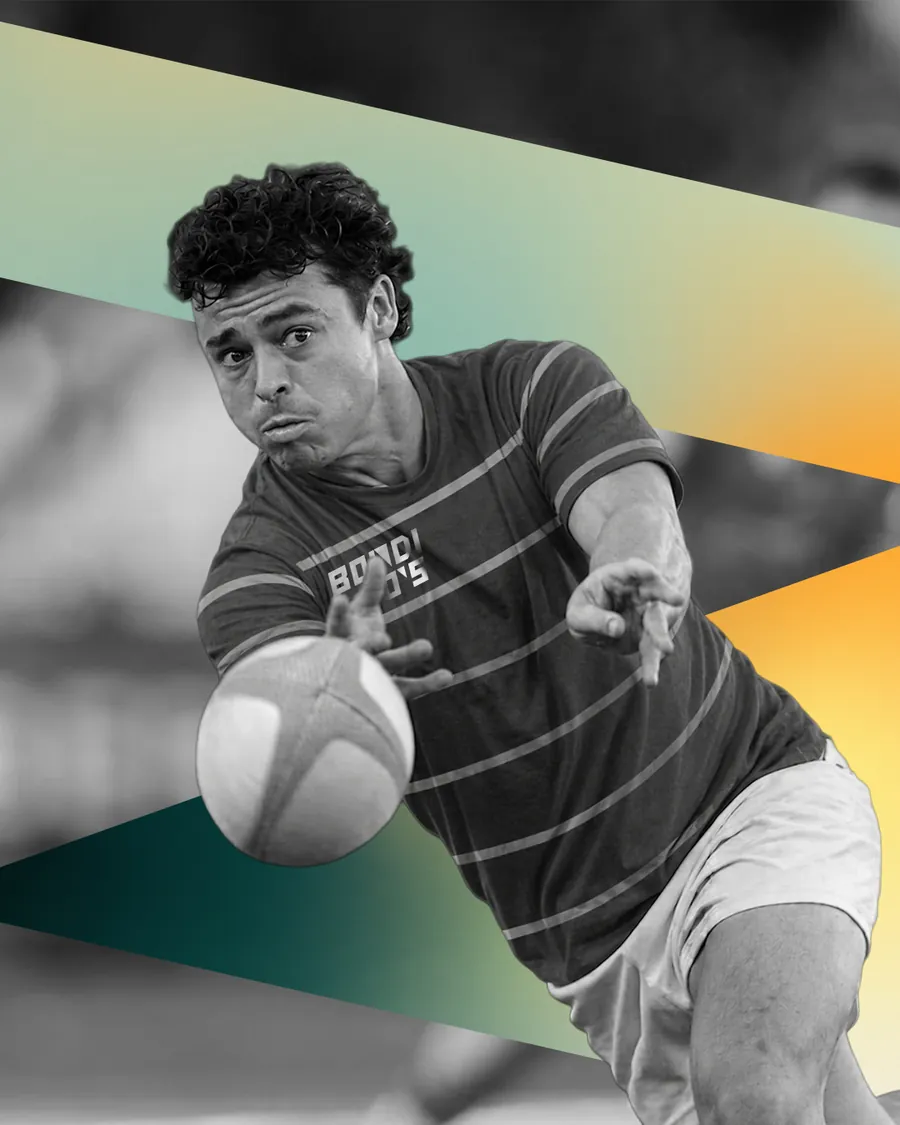 Rugby player passing the ball at full stretch, black and white